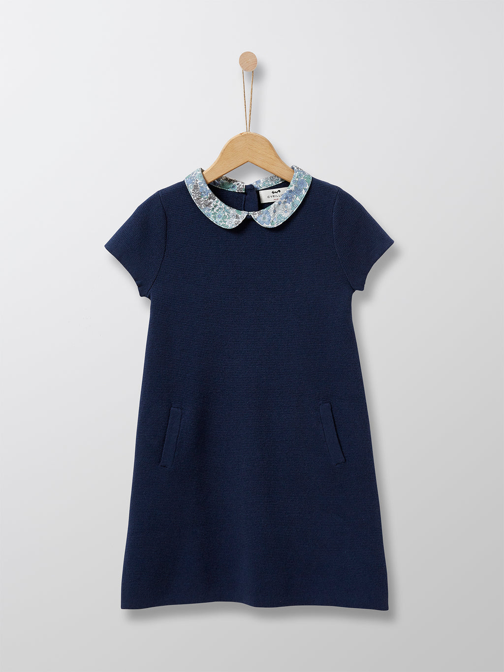 This 100% cotton Navy knit dress is adorned with an elegant collar in Liberty floral fabric. This classic Parisian dress is ideal for special occasions and every day chic wear alike.