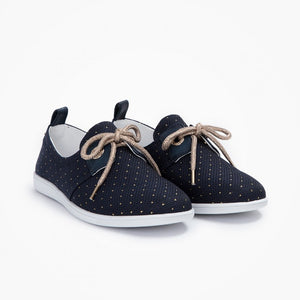These navy canvas urban sneakers come with gold topstitching polka dots, oversized eyelets and golden shoelace for a stylish look, and light rubber sole for comfort.