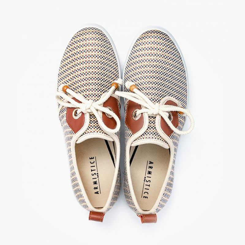 Women's lace-up platform sneakers from France, with 3cm-platform soles and canvas upper in gold stripes, with nautical style rope shoelaces with wood aglets, gold eyelets, and brown leather yokes. 