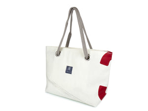 With its blue stripes and red number, the Charlie carry bag by 727Sailbags has been designed for lovers of all things nautical with a strong sense of fashion. Hand-sewn in France, this chic and practical carry bag is made from 100% recycled sails.
