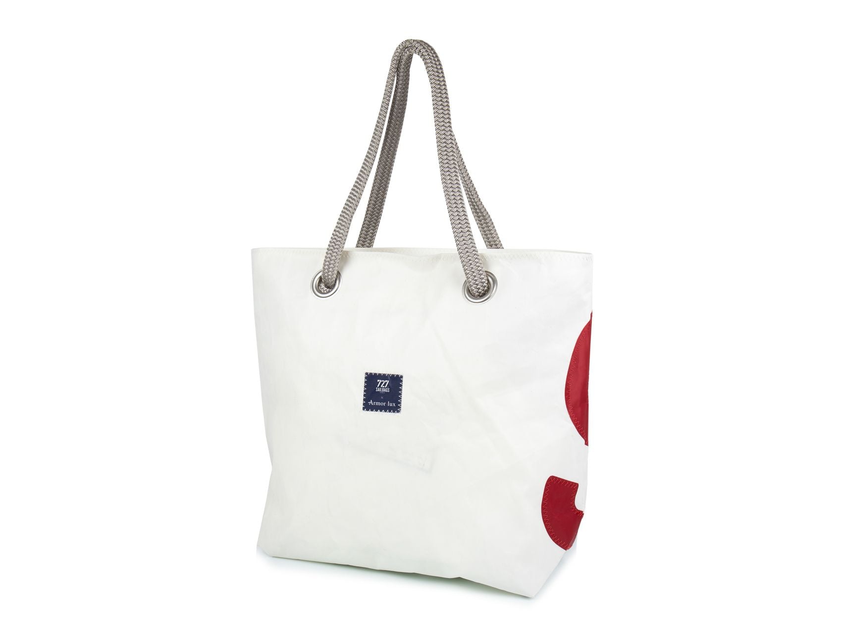 With its blue stripes and red number, this chic and practical tote bag has been sewn by hand from recycled sails and has been designed for lovers of all things nautical and French with a strong sense of style. 